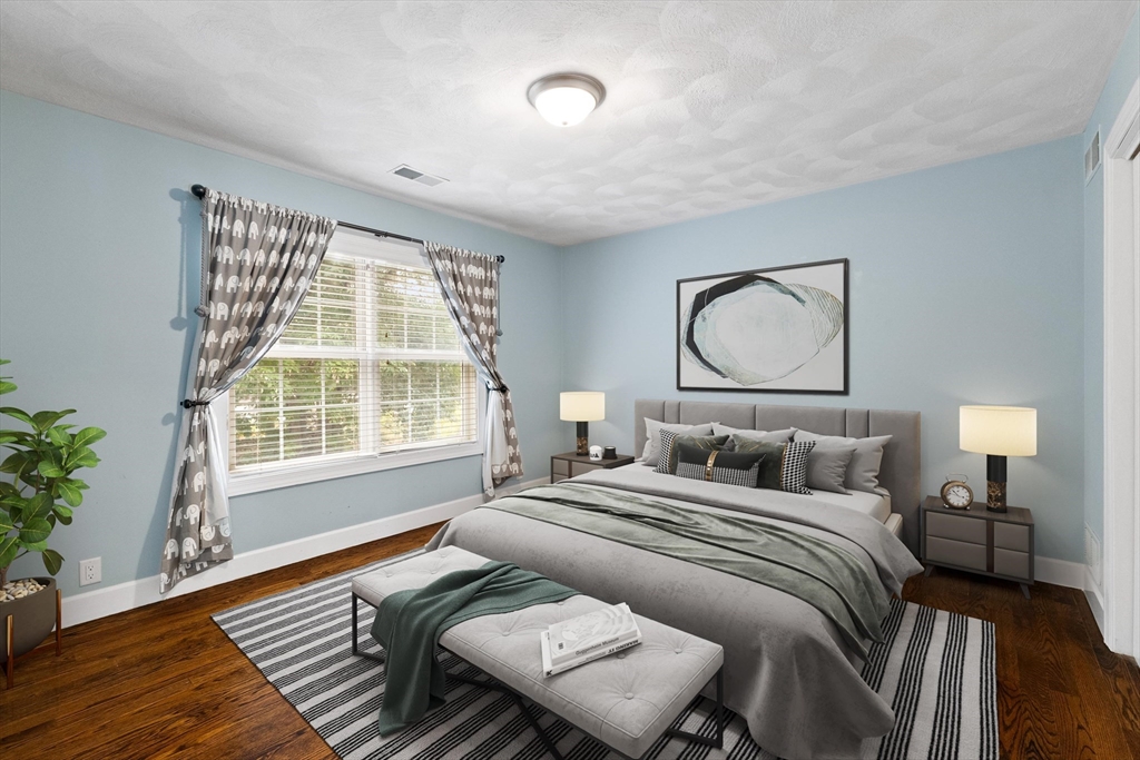 58 Mansfield Road Lynnfield, MA 01940 - Photo 26 of 42 a bedroom with a bed and wooden floor