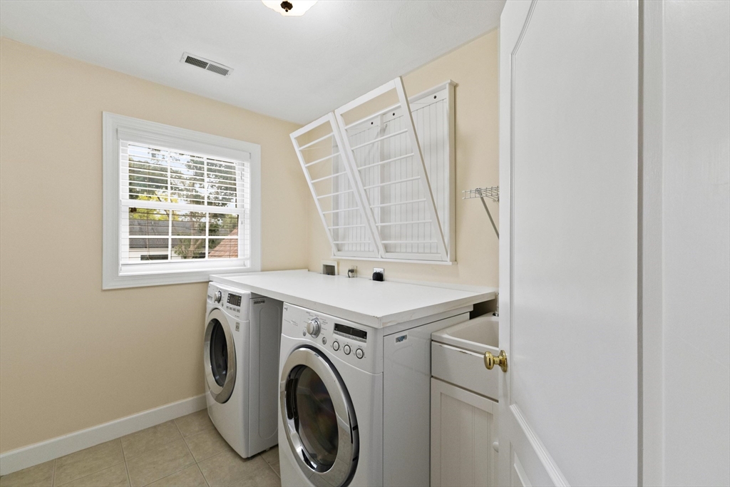 58 Mansfield Road Lynnfield, MA 01940 - Photo 31 of 42 a view of washer and dryer with kitchen in the background