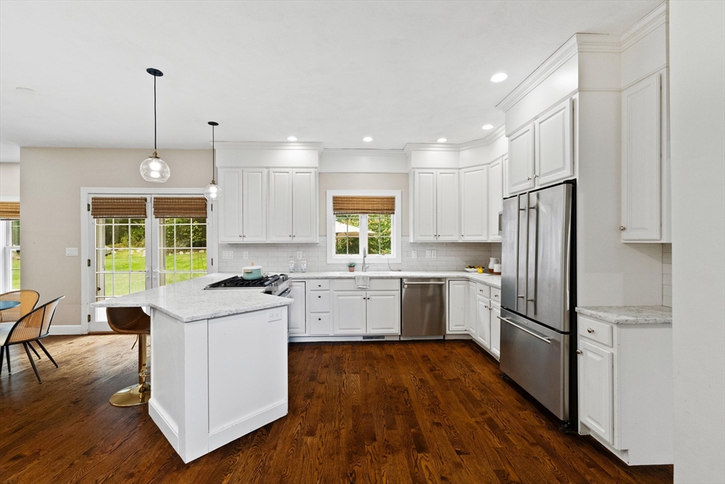 58 Mansfield Road Lynnfield, MA 01940 - Photo 9 of 42 a kitchen with a refrigerator a stove a sink and a wooden floor