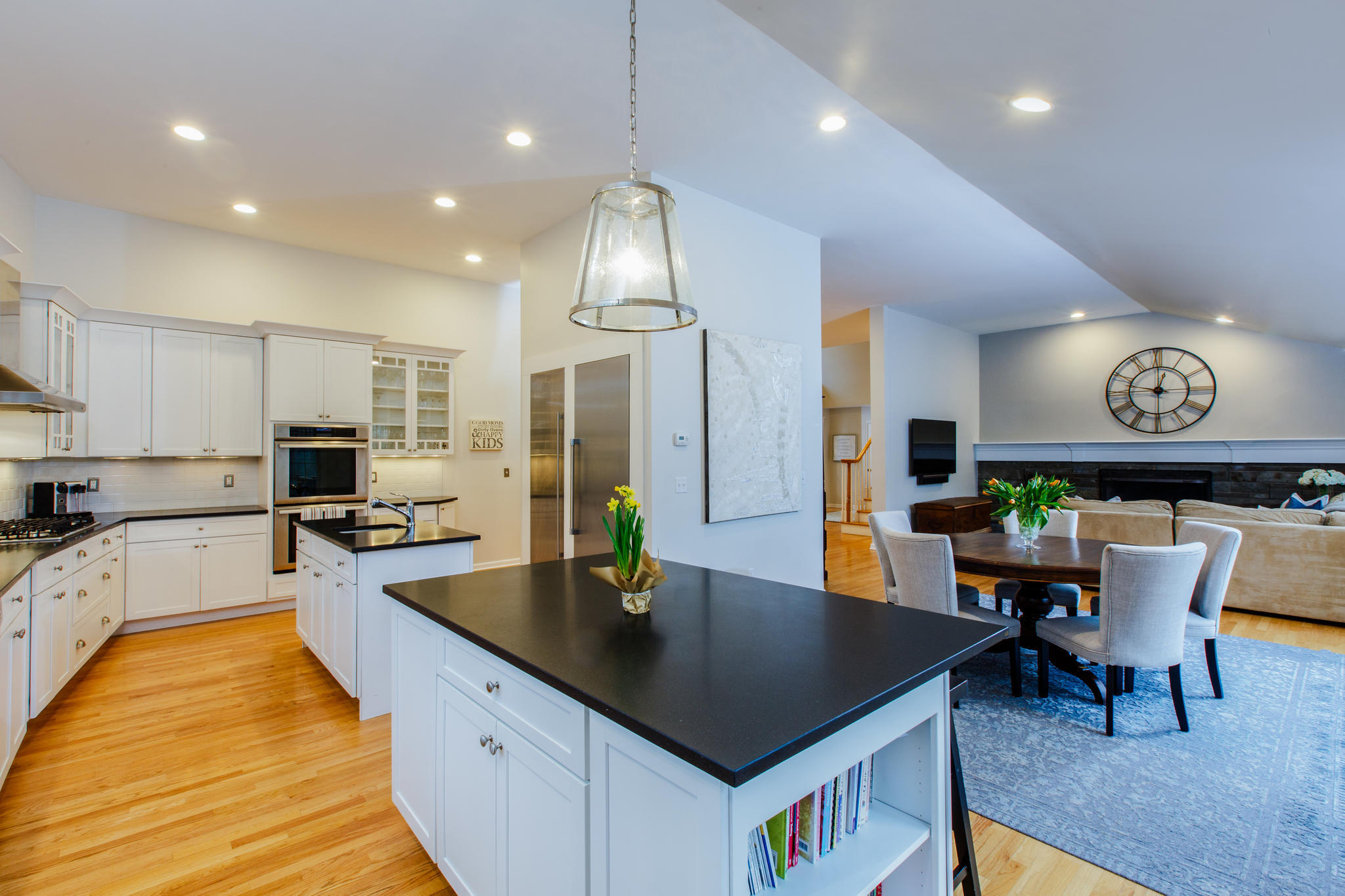 54 Rocky Brook Road New Canaan, CT 06840 - Photo 13 of 25 a kitchen with stainless steel appliances granite countertop a kitchen island a table and chairs in it