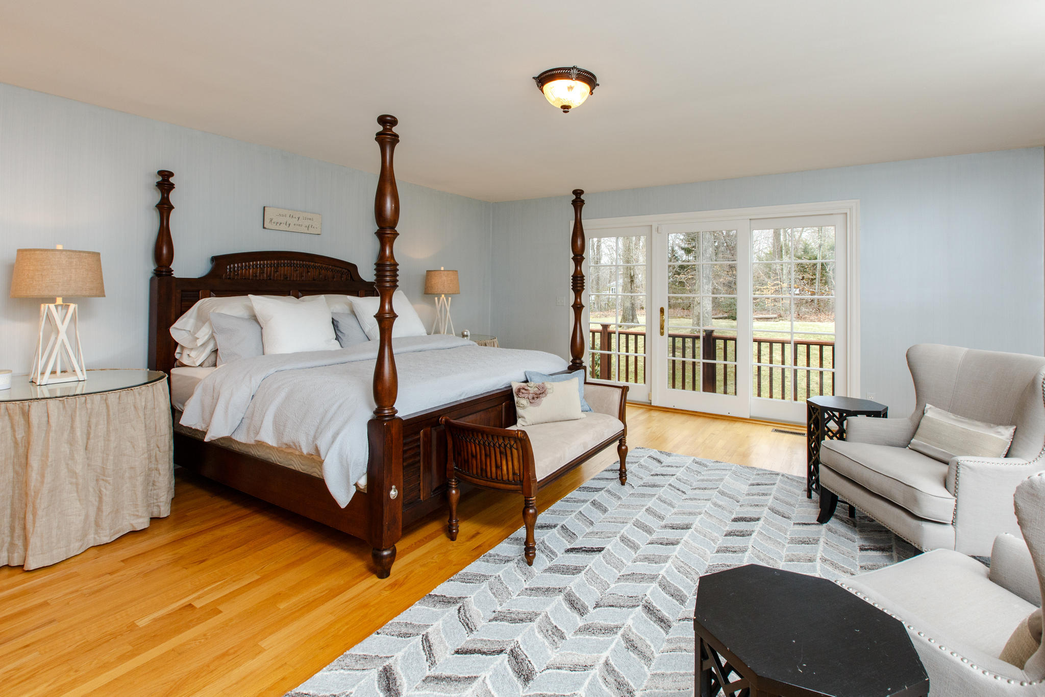 54 Rocky Brook Road New Canaan, CT 06840 - Photo 17 of 25 a bedroom with a bed couch and a large window