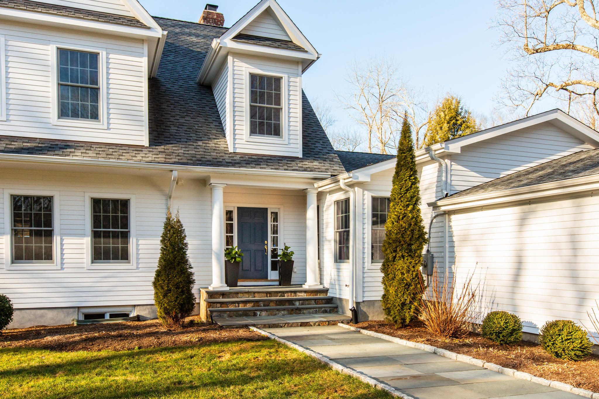 54 Rocky Brook Road New Canaan, CT 06840 - Photo 2 of 25 a front view of a house with a yard
