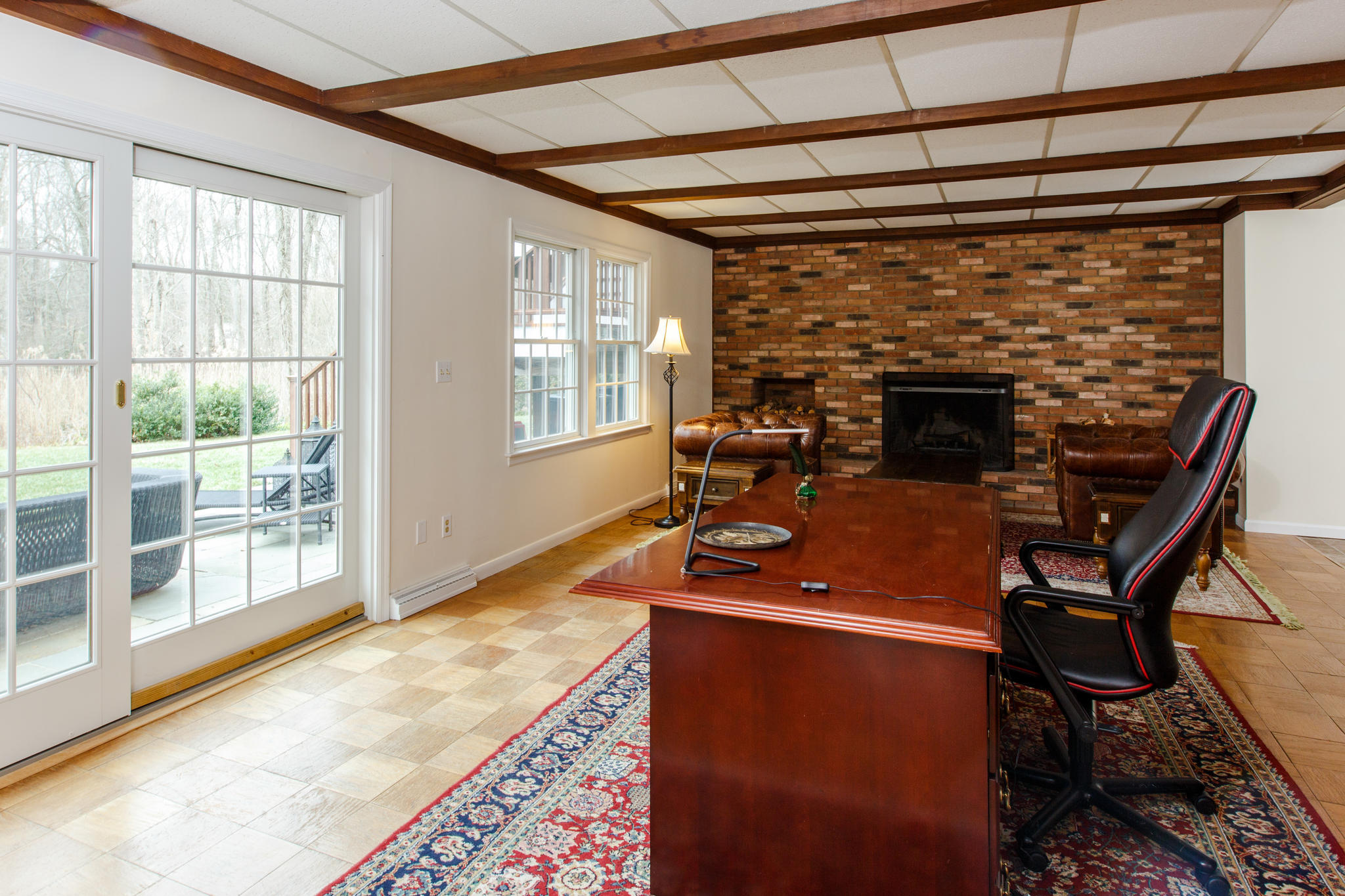 54 Rocky Brook Road New Canaan, CT 06840 - Photo 24 of 25 a room with furniture and a fireplace