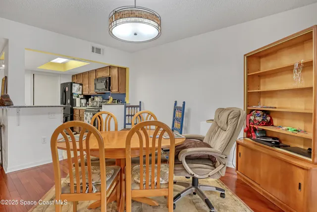 a view of a dining room with furniture and a window