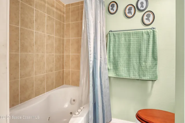 a bathroom with a shower a toilet and a sink