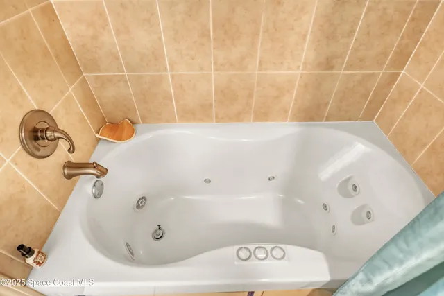 a bathroom with a tub and a shower