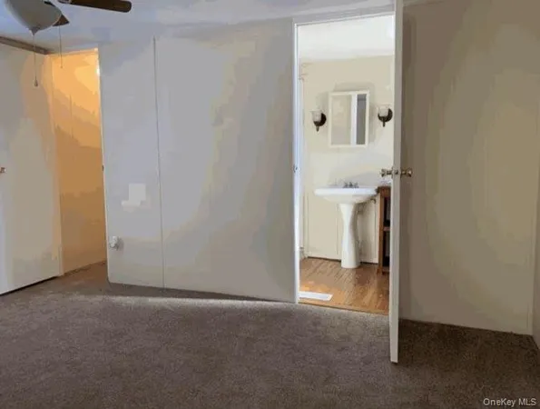 a view of a hallway with a bathroom