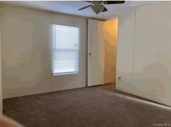 an empty room with a empty space and windows