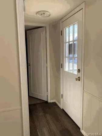 a view of a hallway with wooden floor