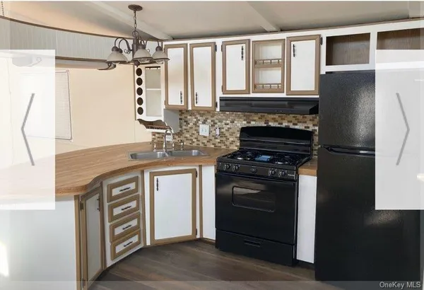 a kitchen with stainless steel appliances granite countertop a stove and a refrigerator