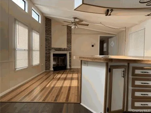 a view of a livingroom with a fireplace and window