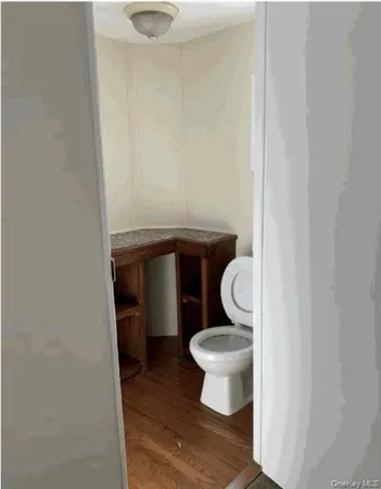 a bathroom with a granite countertop toilet and a sink