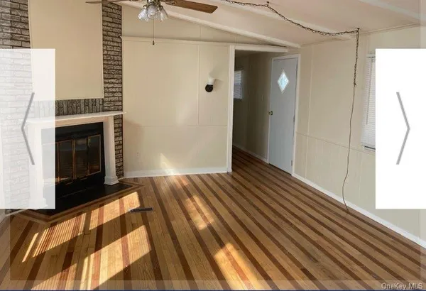 a view of hallway with wooden floor and staircase