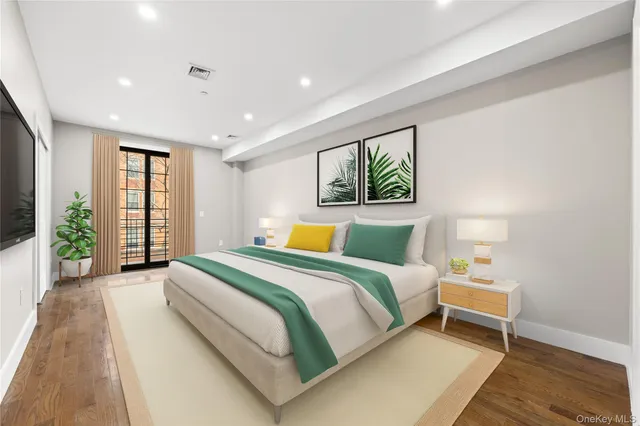 a bedroom with a large bed and a large window