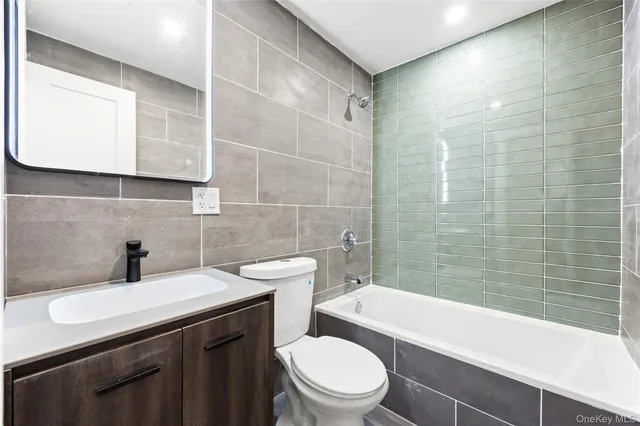 a bedroom with bed and a potted plant