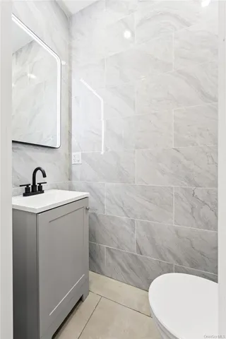 a kitchen with kitchen island white cabinets and stainless steel appliances