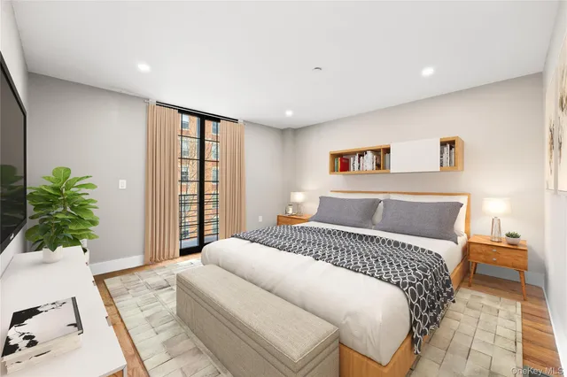 a bedroom with a bed and a flat screen tv