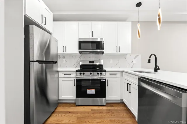 a kitchen with a stove sink and refrigerator