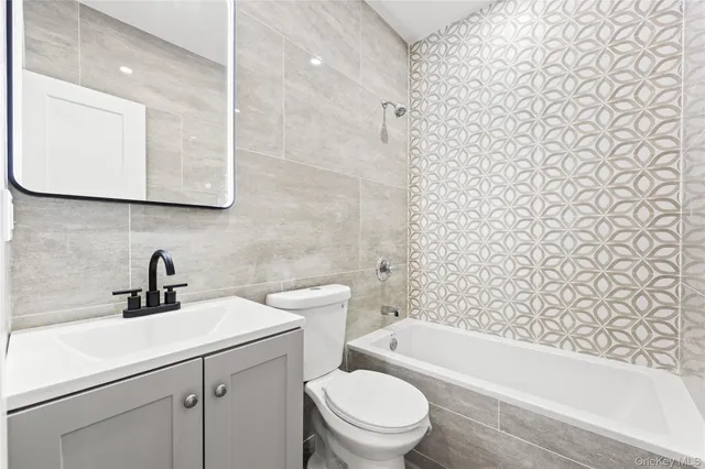 a bathroom with a sink a toilet and a bathtub