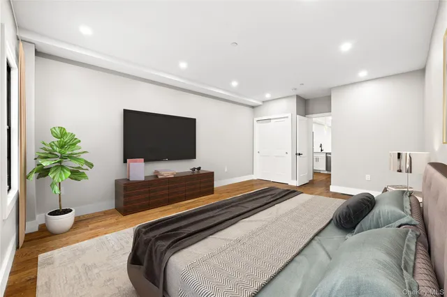 a bedroom with a bed and a flat screen television