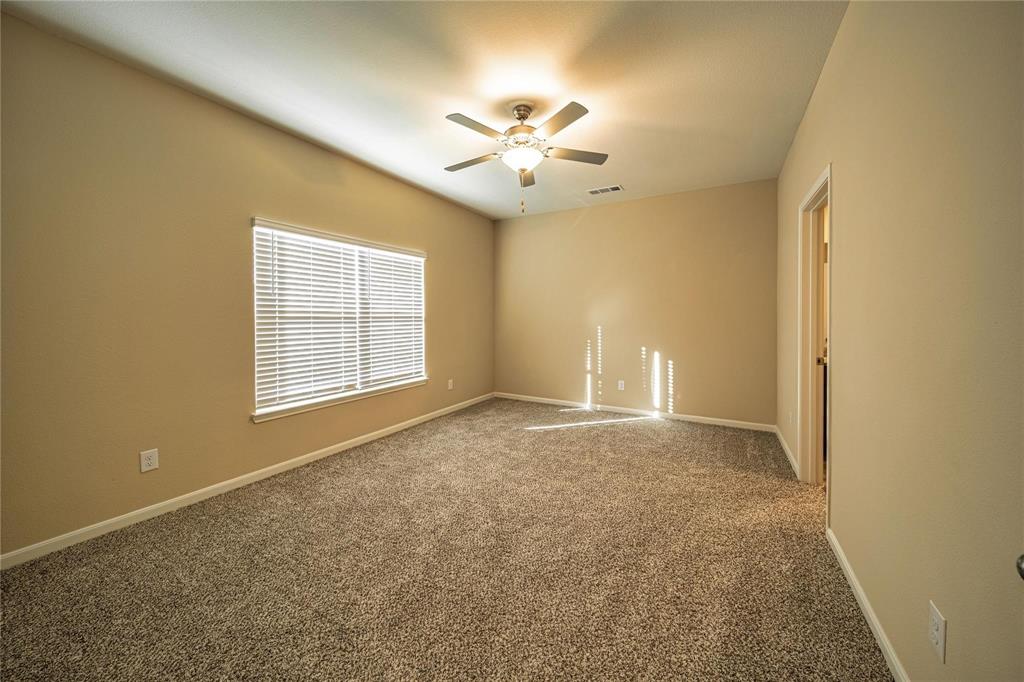 274 Honeysuckle Lane Princeton, TX 75407 - Photo 12 of 35 Carpeted spare room featuring baseboards and ceiling fan