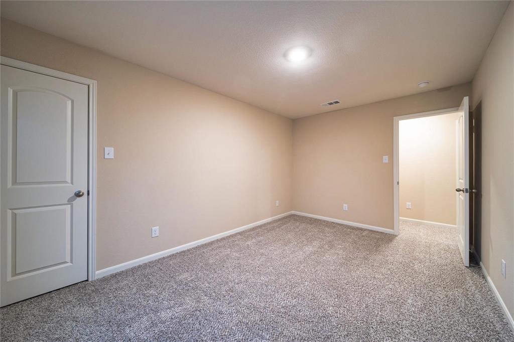 274 Honeysuckle Lane Princeton, TX 75407 - Photo 19 of 35 Empty room with light carpet and baseboards