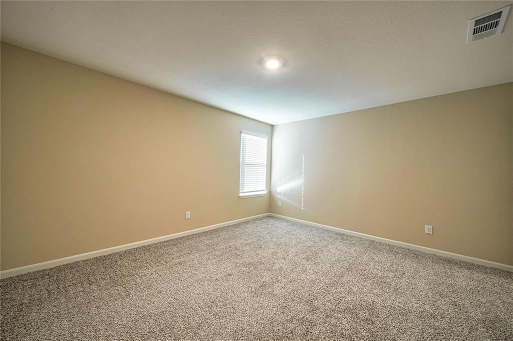 274 Honeysuckle Lane Princeton, TX 75407 - Photo 26 of 35 Carpeted empty room featuring baseboards and a textured ceiling