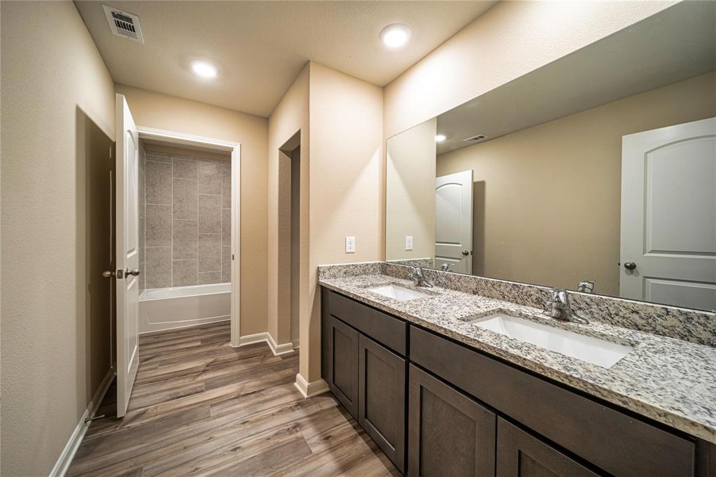274 Honeysuckle Lane Princeton, TX 75407 - Photo 28 of 35 Full bathroom with double vanity, light wood-style flooring, and recessed lighting