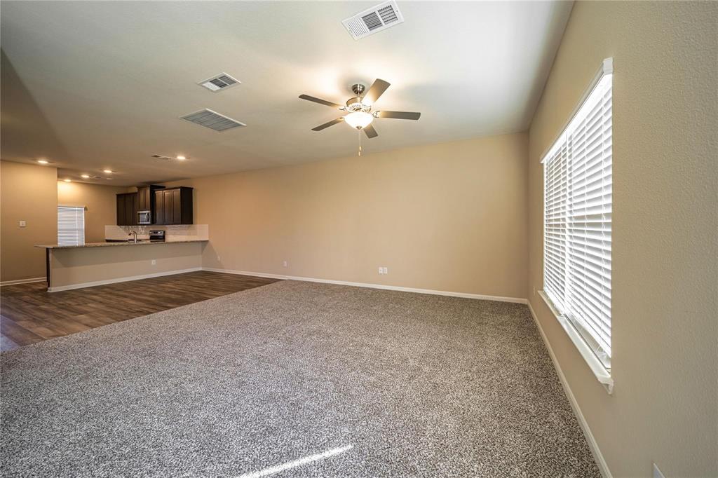 274 Honeysuckle Lane Princeton, TX 75407 - Photo 9 of 35 Unfurnished living room featuring dark colored carpet, ceiling fan, and recessed lighting