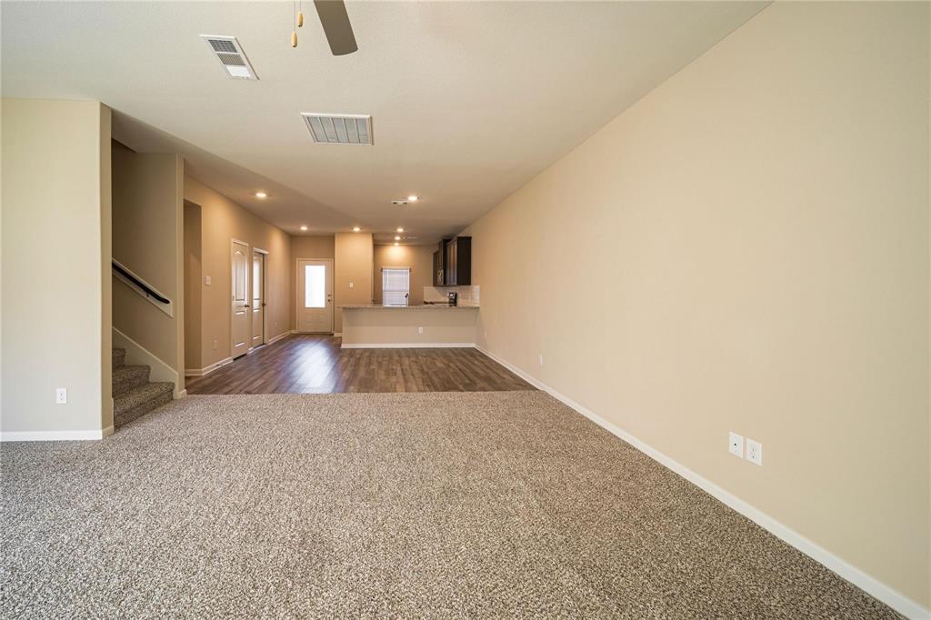 274 Honeysuckle Lane Princeton, TX 75407 - Photo 10 of 35 Unfurnished room featuring dark carpet, stairs, recessed lighting, and ceiling fan