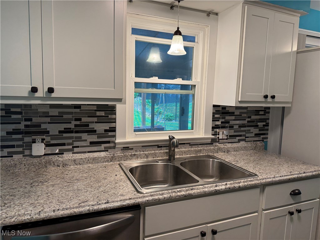 1139 Kessel Avenue Akron, OH 44310 - Photo 5 of 36 Kitchen with dishwasher, a sink, tasteful backsplash, and hanging light fixtures
