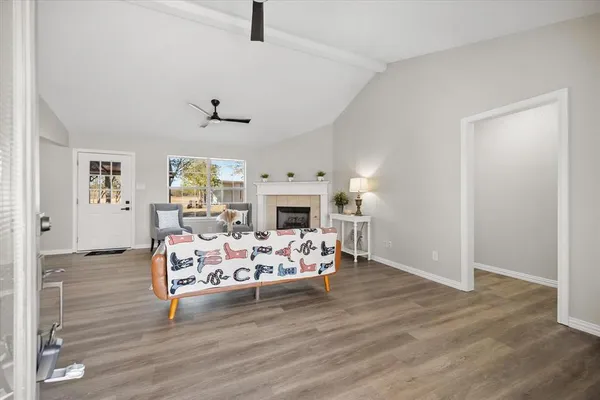 a living room with fireplace furniture and a wooden floor