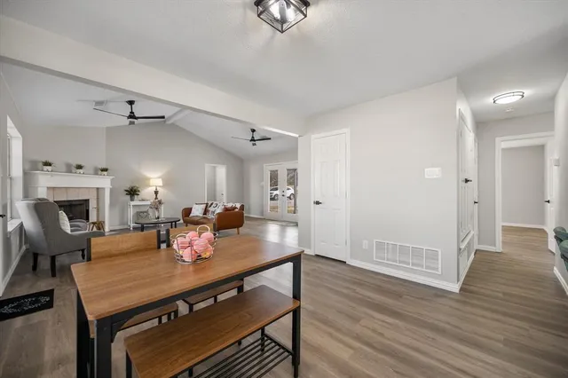 a view of a dining room with furniture a chandelier and wooden floor