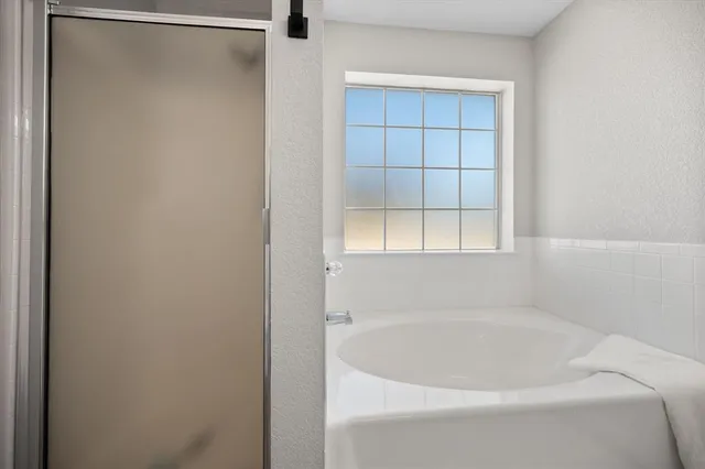 a white bath tub sitting in a bathroom