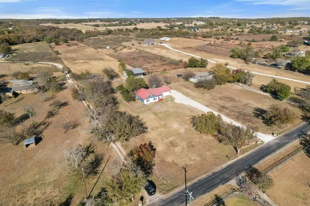an aerial view of a house with a yard