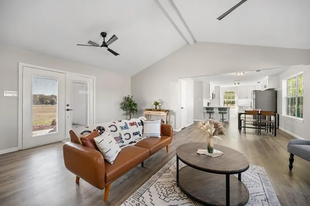 a living room with furniture and a wooden floor