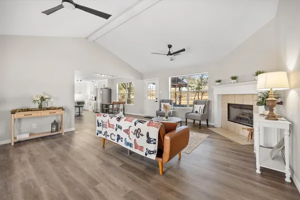 a living room with furniture fireplace and window