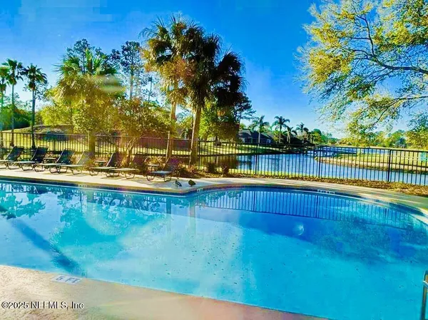 a view of a swimming pool with a table and chairs
