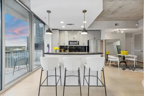 a view of a hallway with dining area and glass door