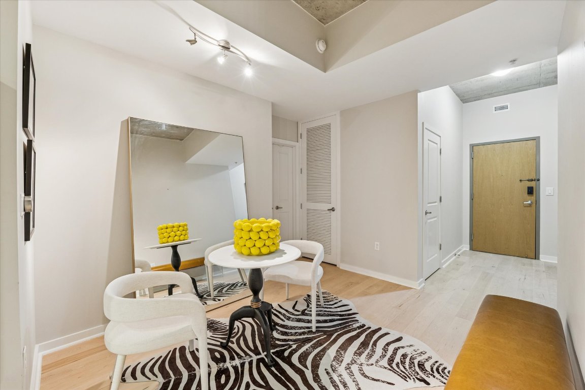 360 Nueces Street, Unit 1417 Austin, TX 78701 - Photo 15 of 40 a bedroom with furniture and a wooden floor