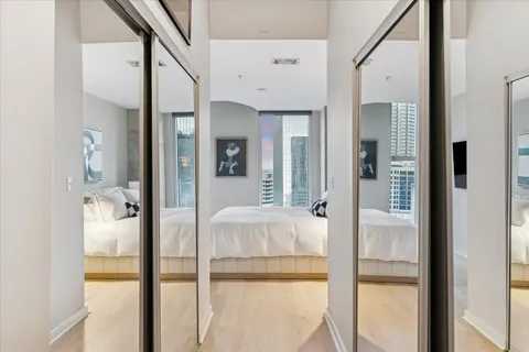 a bathroom with a granite countertop sink a toilet and a mirror