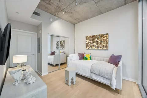 a bedroom with a bed and a couch