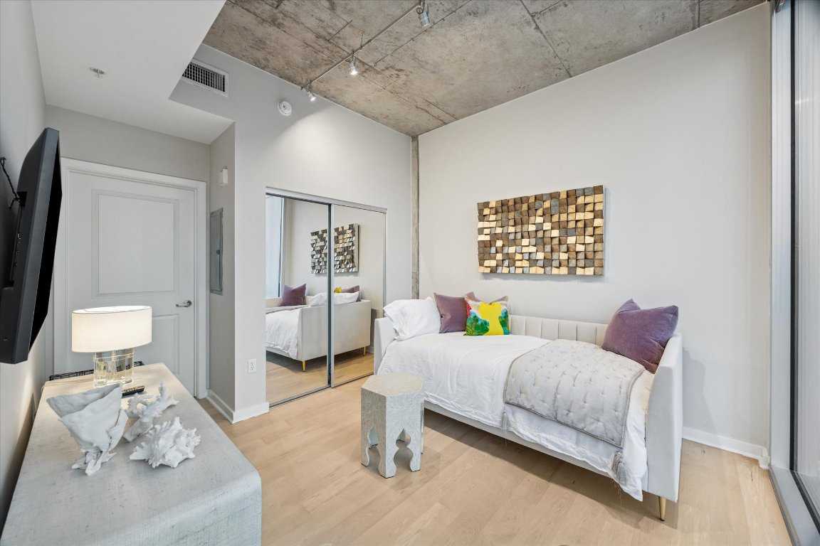 360 Nueces Street, Unit 1417 Austin, TX 78701 - Photo 24 of 40 a bedroom with a bed and furniture