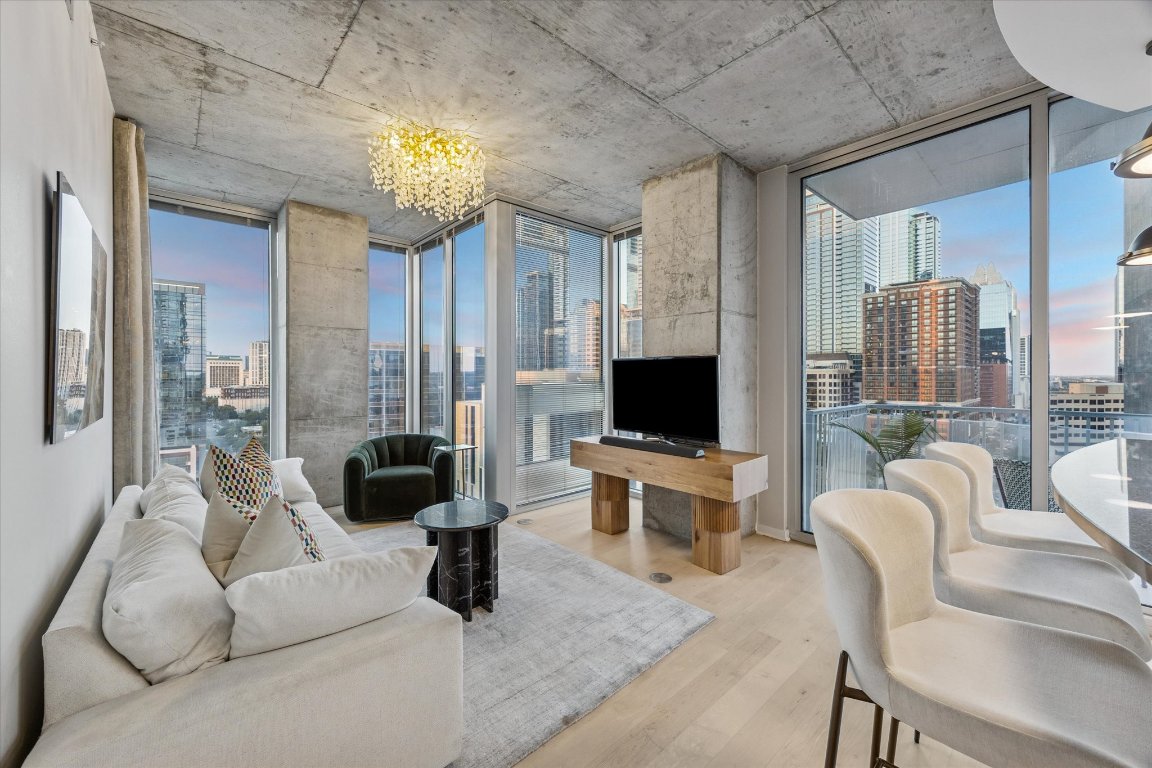 360 Nueces Street, Unit 1417 Austin, TX 78701 - Photo 2 of 40 a living room with furniture a flat screen tv and a large window