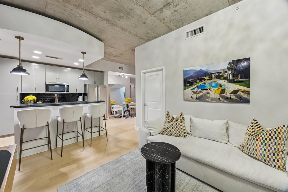 360 Nueces Street, Unit 1417 Austin, TX 78701 - Photo 5 of 40 a living room with furniture and kitchen view