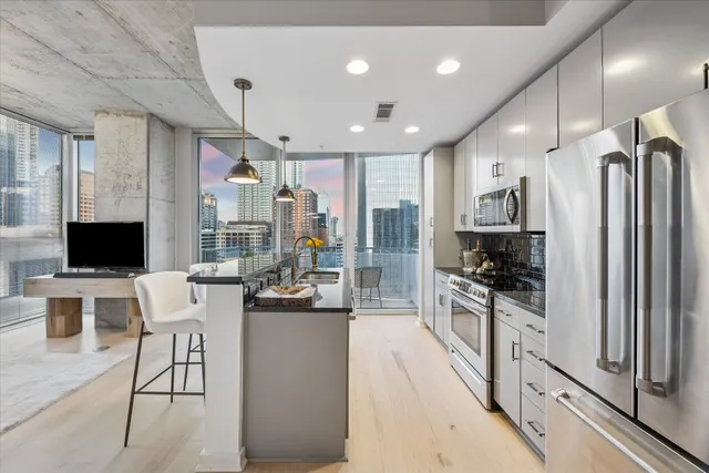 a living room with furniture and kitchen view