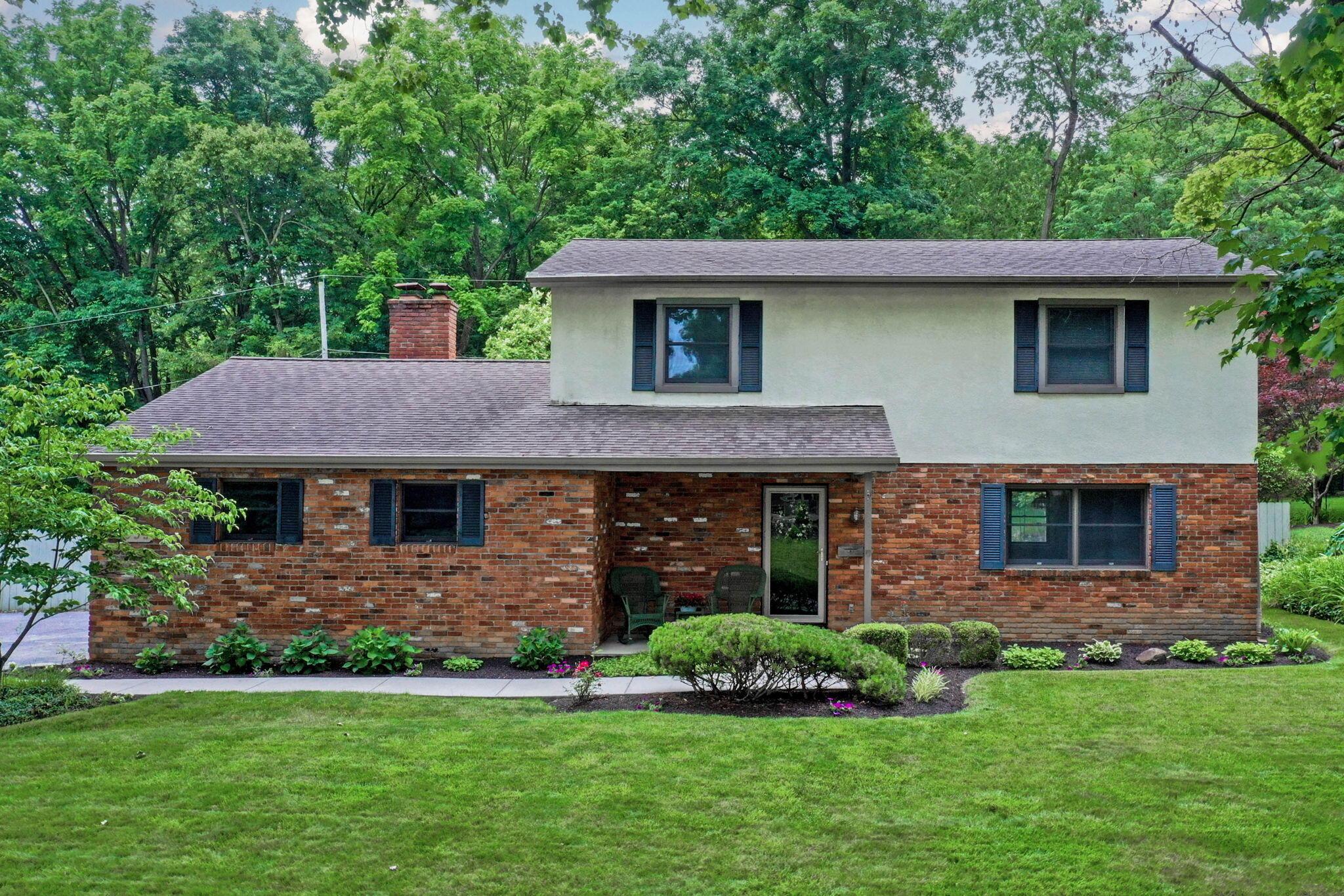 999 Birchmont Road Columbus, OH 43220 - Photo 2 of 53 Great view of the front of the home with porch and greenery.