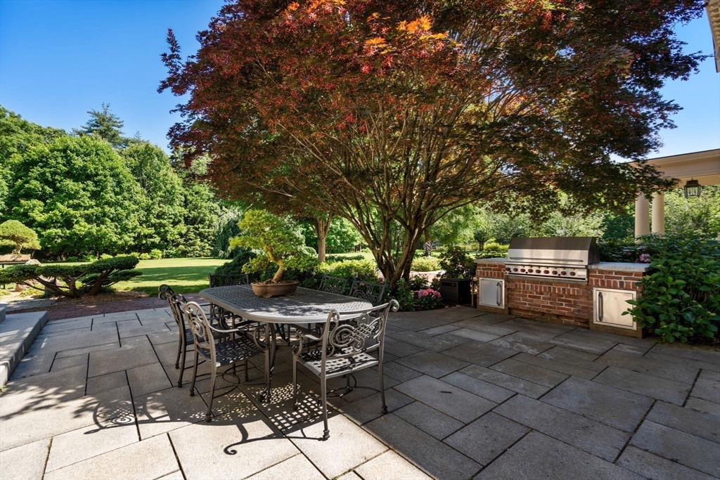 495 Hugh Cargill Road Concord, MA 01742 - Photo 14 of 42 a view of a chairs and table in backyard