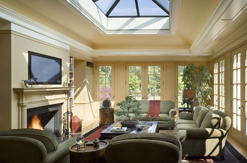 495 Hugh Cargill Road Concord, MA 01742 - Photo 26 of 42 a living room with furniture a flat screen tv and a fireplace