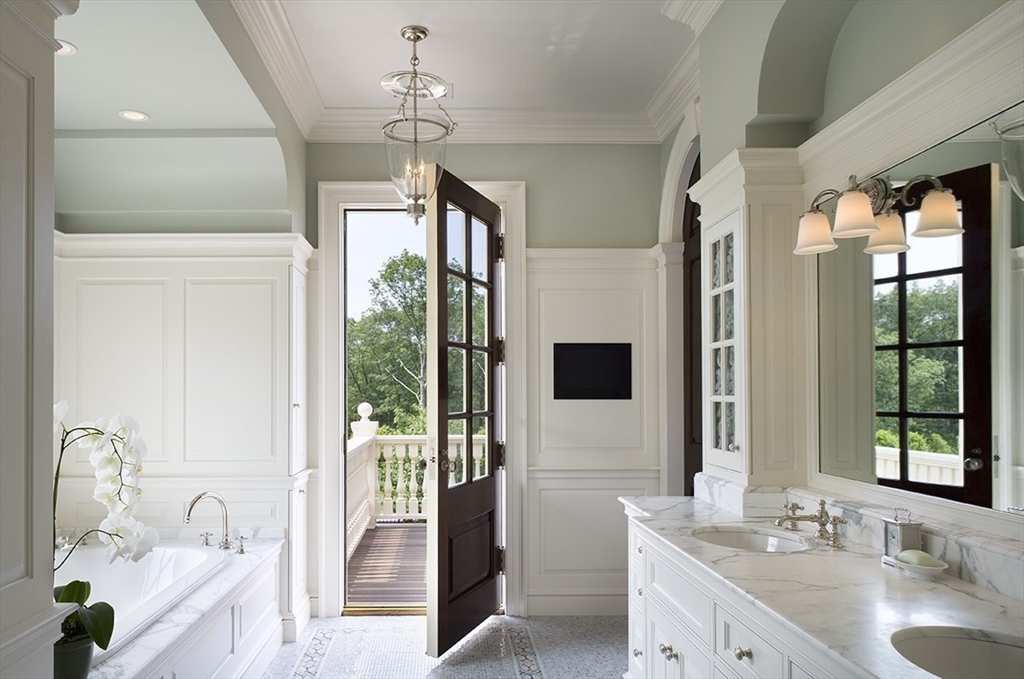 495 Hugh Cargill Road Concord, MA 01742 - Photo 34 of 42 a spacious bathroom with a double vanity sink a large mirror and a bathtub